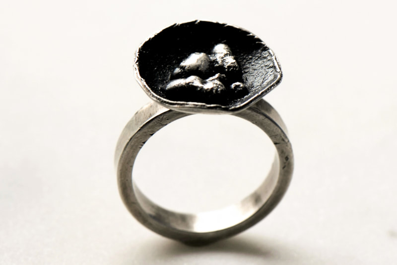 Silver ring with flowering top.